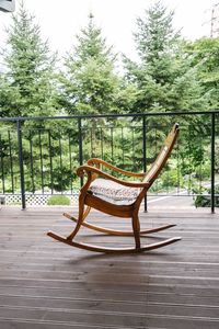 Empty chairs against trees