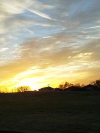 Scenic view of field against sky during sunset