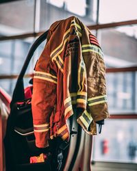 Jacket with purse hanging against window