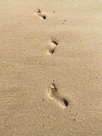 High angle view of footprints on sand at beach