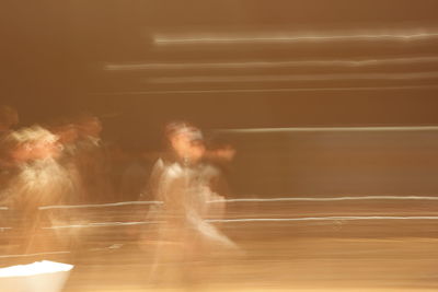 Blurred motion of woman at night