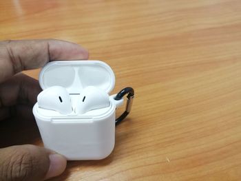 Close-up of hand holding tea cup on table