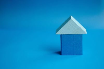 Close-up of open sign against blue background