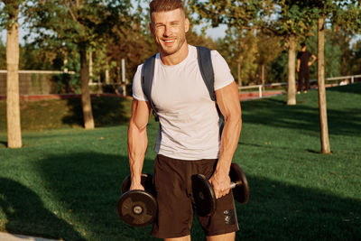 Portrait of young man exercising in park