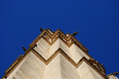 Low angle view of building against clear blue sky