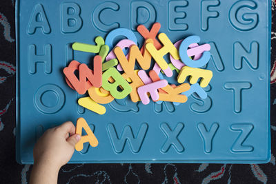 Cropped hand of person holding jigsaw puzzle