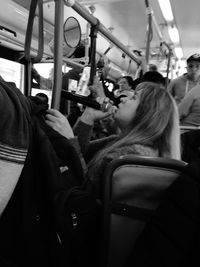 Rear view of woman sitting in train