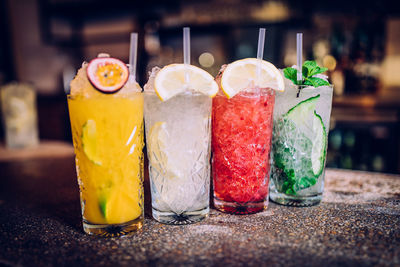 Close-up of drinks served in glasses on marble