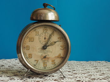 Close-up of clock on sand