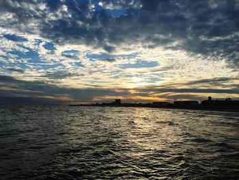 Scenic view of calm sea against cloudy sky