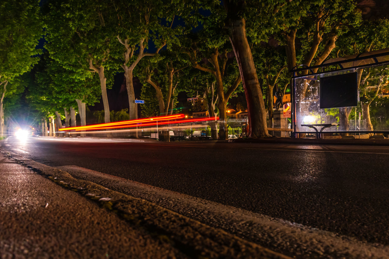 VIEW OF LIGHT TRAILS ON STREET AT NIGHT