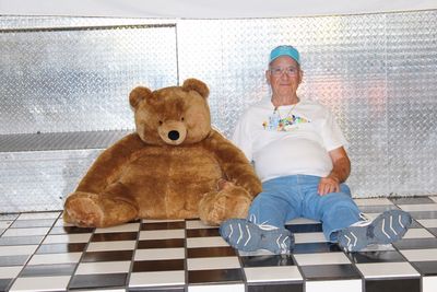 Portrait of man sitting with toy on floor