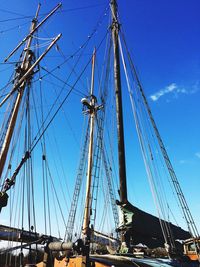 Low angle view of sailboat against blue sky