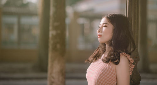 Beautiful young woman looking away