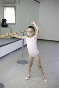 Portrait of young woman exercising in gym