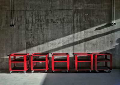 Tray trolleys against wall in warehouse