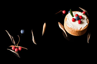 Close-up of cake against black background