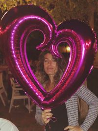 Portrait of woman with pink mask