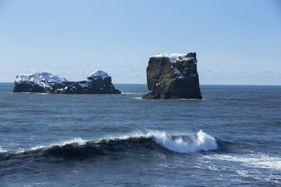 Basalt stones in the ocean, vik, iceland in wintertime