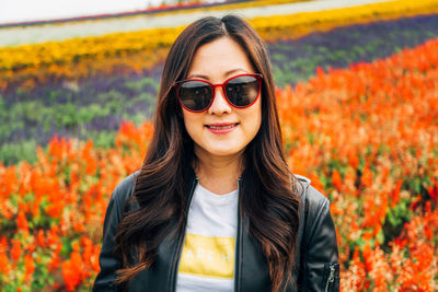 Portrait of young woman against field