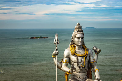 Shiva statue isolated at murdeshwar temple aerial shots with arabian sea in the backdrop