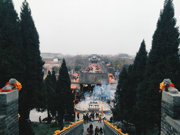 Group of people in temple against sky