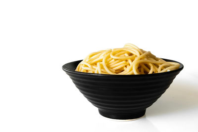 Close-up of bread in bowl against white background