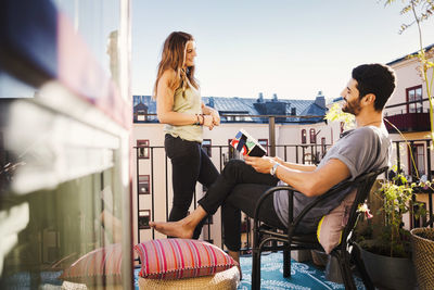 Happy couple planning vacations at balcony