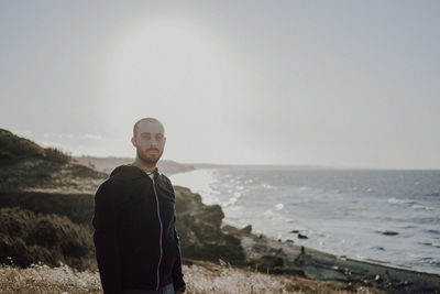 Man standing on beach against sky