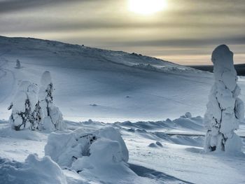 Scenic view of snow covered mountains against sky