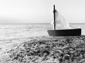 Close-up of boat on beach against sky