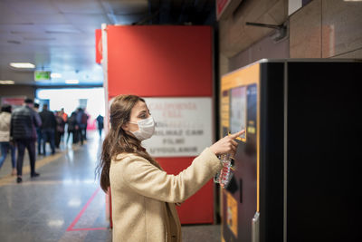 Rear view of woman looking at mobile phone