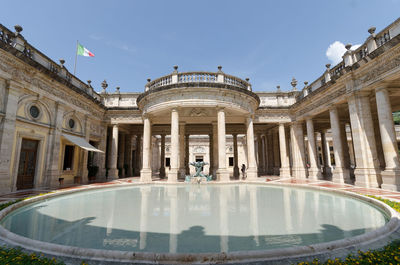 Reflection of building in water to montecatini