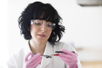 Young woman scientist portrait with gloves and safety glass