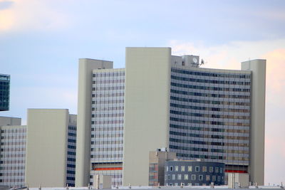 Low angle view of modern buildings in city against sky