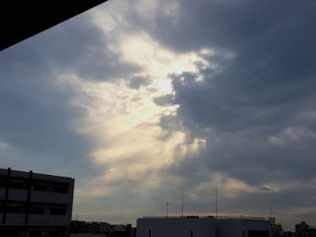 Low angle view of buildings against cloudy sky