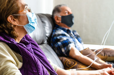 Senior couple wearing mask at hospital