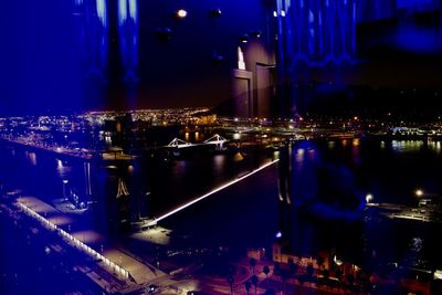 Illuminated buildings by street in city at night