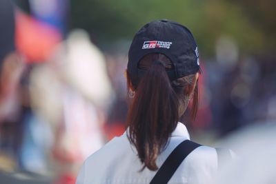 Rear view of a woman with umbrella