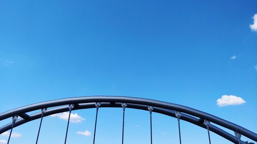 Low angle view of bridge against blue sky