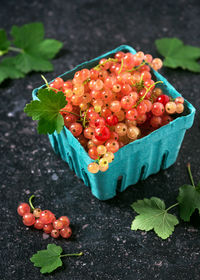 Fresh rosa and white currants in a cardboard box. harvest of summer berries. healthy eating concept.