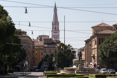 Street amidst buildings in city against sky