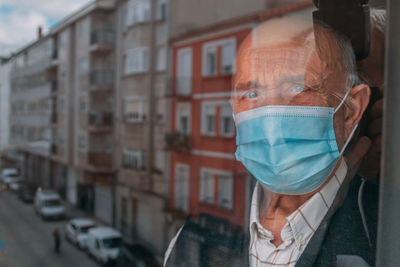 Portrait of man with buildings in background