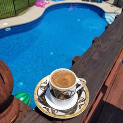 High angle view of coffee on table at swimming pool