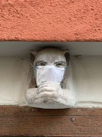 Low angle view of statue against wall