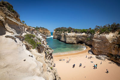 Scenic view of beach against clear blue sky