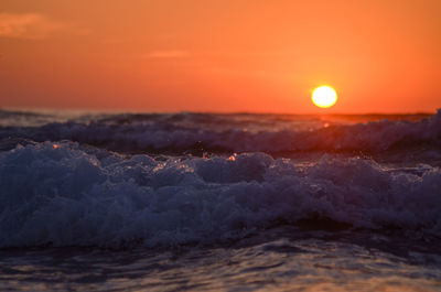 Scenic view of sea against orange sky