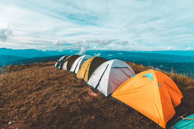 Panoramic view of tent on mountain against sky