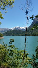 Scenic view of lake and mountains against clear sky