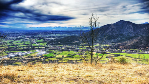 Scenic view of mountains against cloudy sky